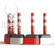 Red and white road rocks with orange and white poles